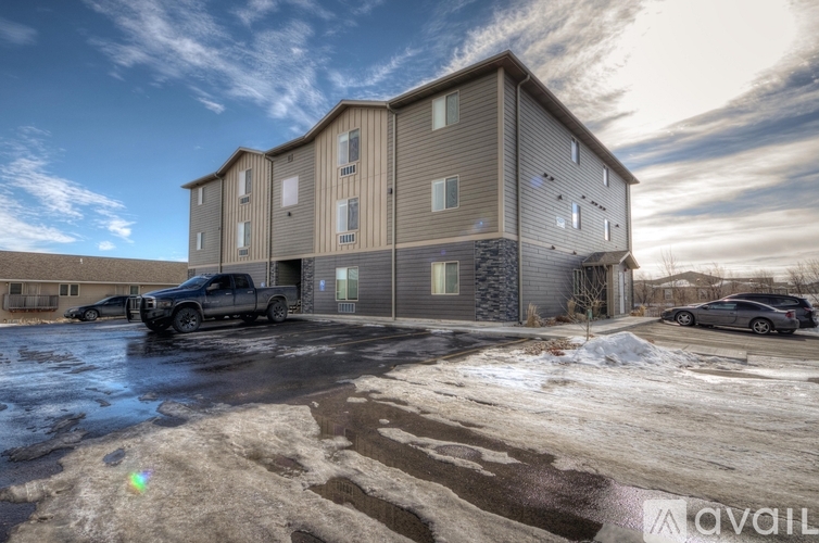 A large building with a parking lot in front of it.