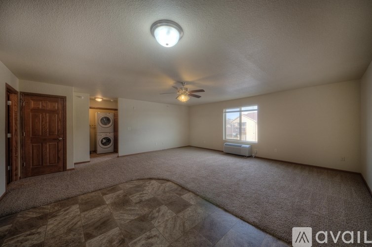 A room with a ceiling fan and a window with blinds.