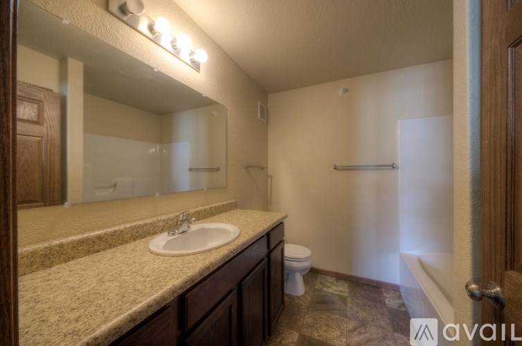 A bathroom with a sink, toilet, and shower.