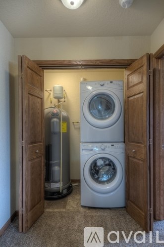 A small laundry room with a washer and dryer.