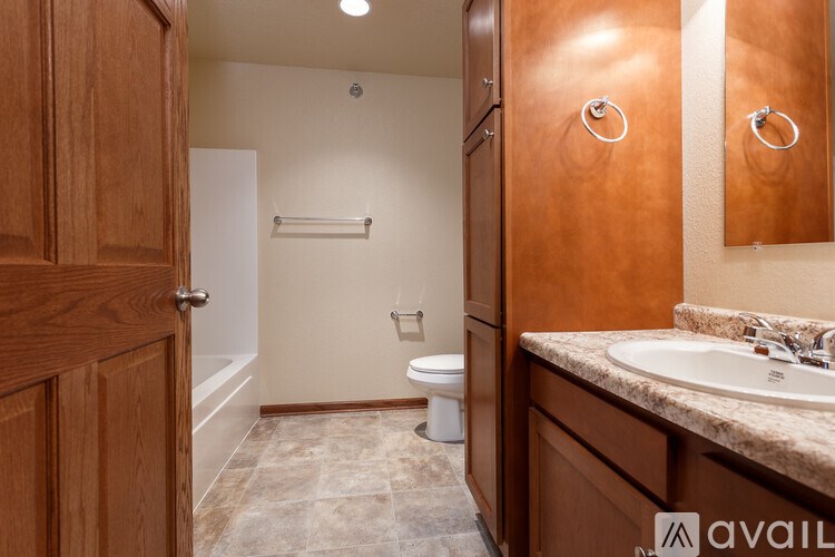 A bathroom with a toilet, sink, and a shower stall.