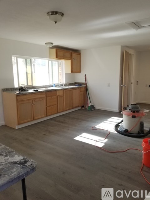 A kitchen with wooden cabinets and a concrete table.