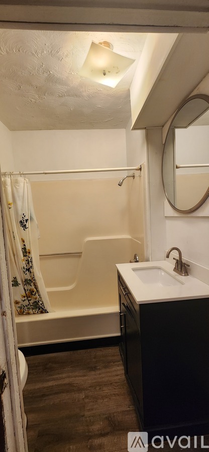 A bathroom with a white sink and a bathtub.