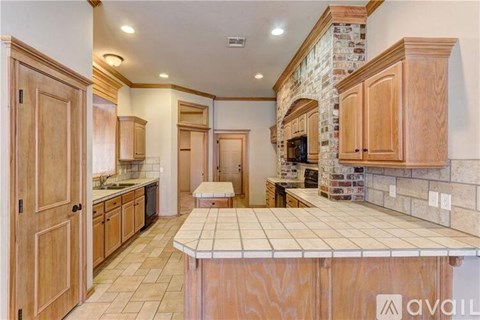 A kitchen with wooden cabinets and a stone backsplash is available.