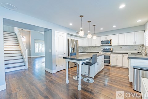A modern kitchen with a dining table and chairs.