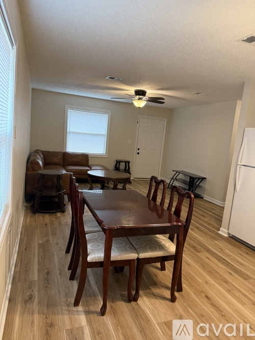 A dining room with a table and chairs.