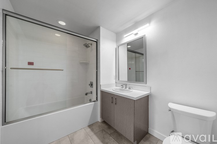 A kitchen with a stainless steel refrigerator, microwave, and stove.
