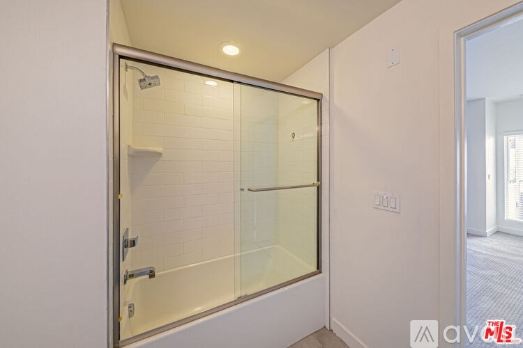 A glass door with a handle and a lock is open.