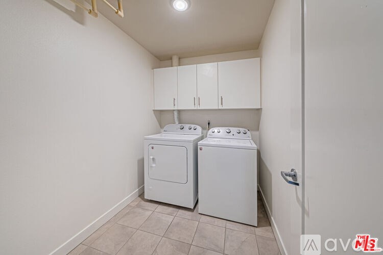 A small laundry room with a washer and dryer.