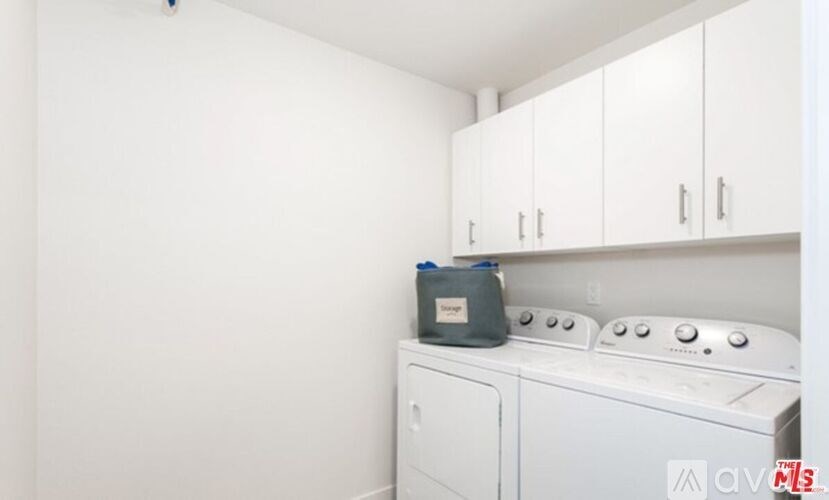 A washing machine and dryer are in a small laundry room.