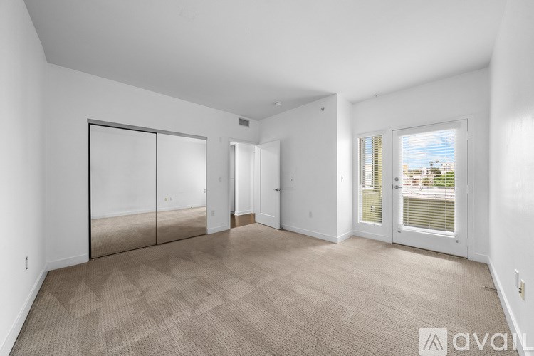 A gym with treadmills, elliptical machines, and a wall mural.