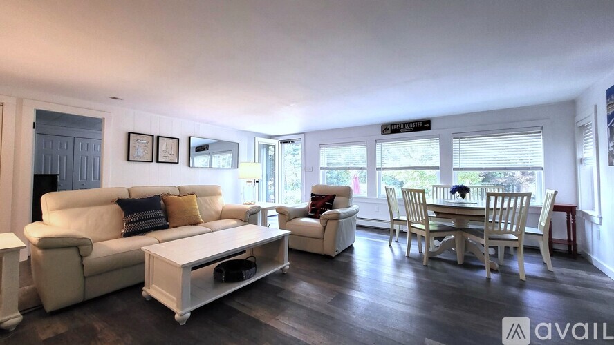 A living room with a white couch and a coffee table.