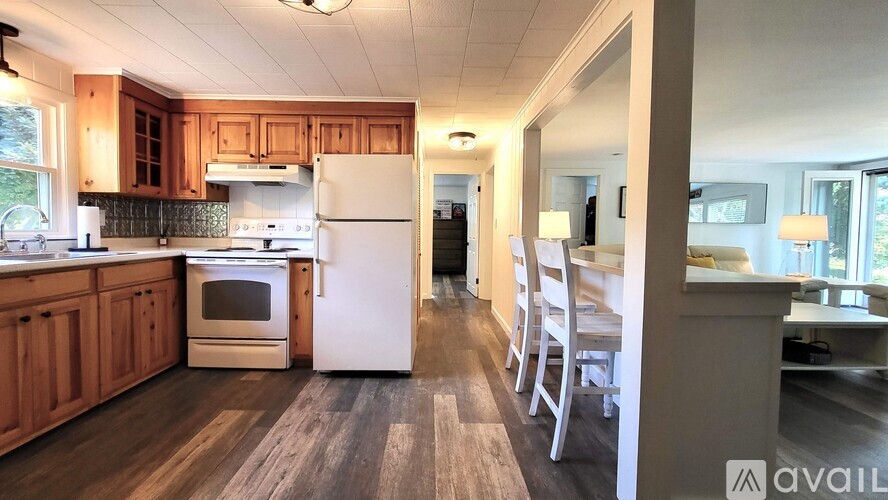 A kitchen with wooden cabinets and a white refrigerator.