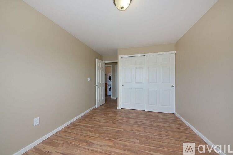 A room with wooden floors and a white door.