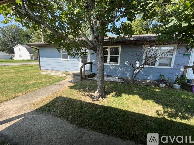 A house with a tree in front of it.