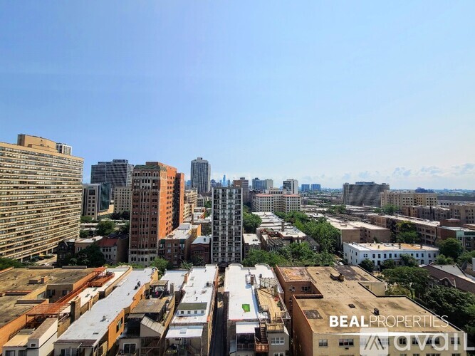 A cityscape with buildings of various heights and a clear sky.