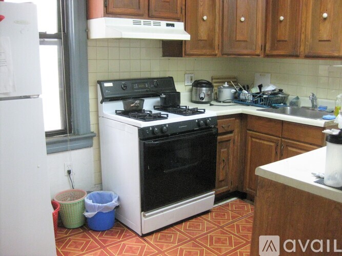 A kitchen with a black stove top oven and white appliances.