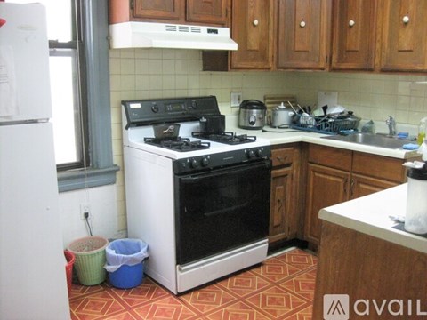 A kitchen with a black stove top oven and white appliances.