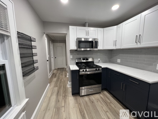 A kitchen with a stove, oven, and cabinets.