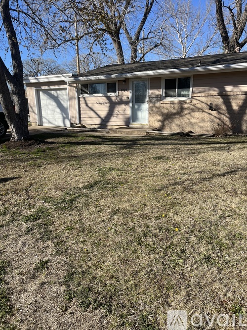 A house with a brown roof and a white garage door.