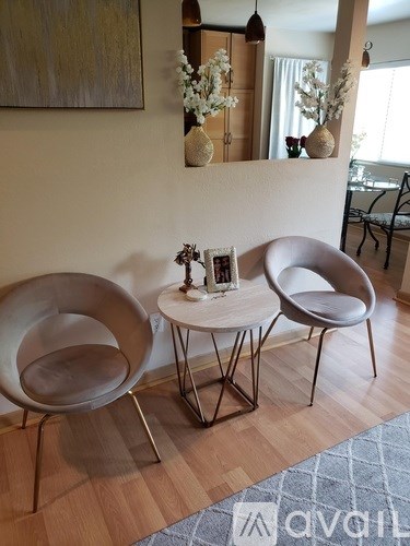 Two chairs and a small table are in a room.