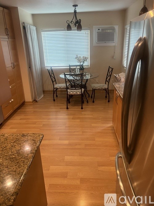 A kitchen with a table and chairs in the middle.