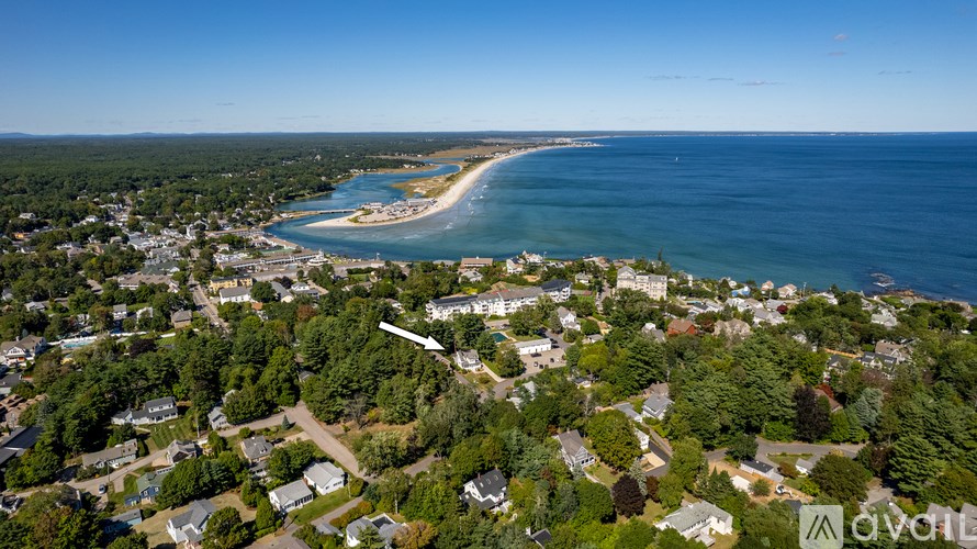 A bird's eye view of a coastal town with a beach and a bay.