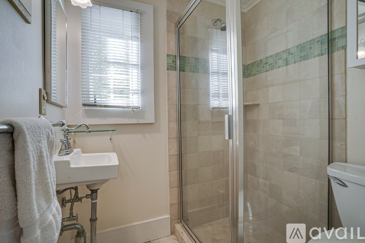A bathroom with a sink, toilet, and shower.