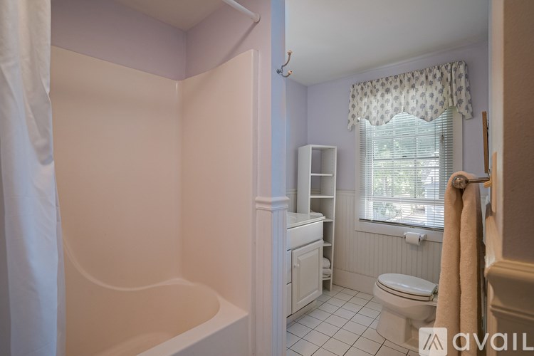 A bathroom with a toilet, sink, and bathtub.