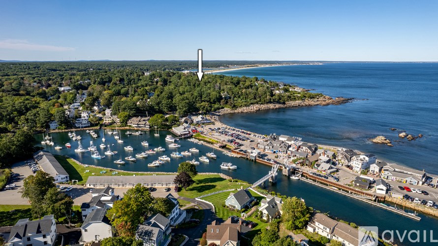 A lighthouse stands tall on a small island in the distance.