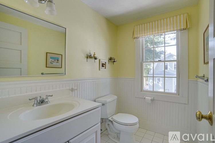 A bathroom with a white sink and toilet.