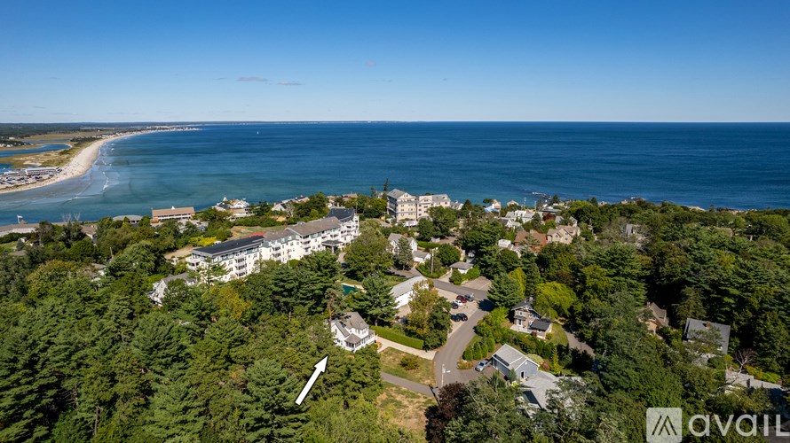 A bird's eye view of a resort with a beach and the ocean in the background.