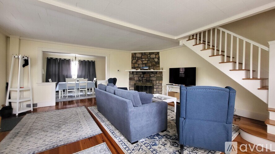 A living room with a blue couch and a television.