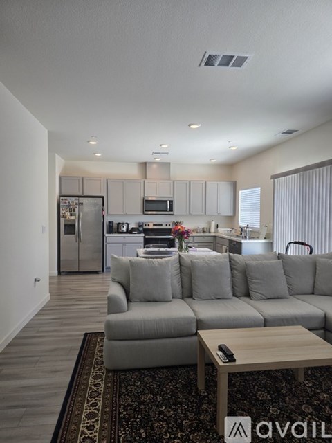 A modern living room with a grey sofa and a coffee table.