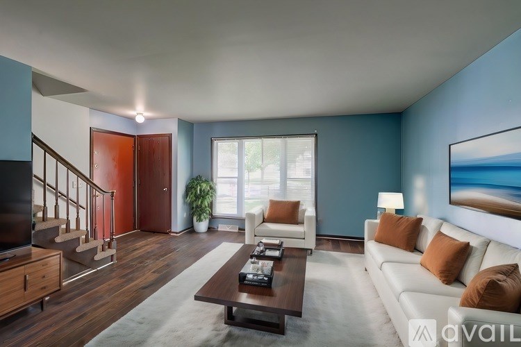 A living room with a white couch and a coffee table.