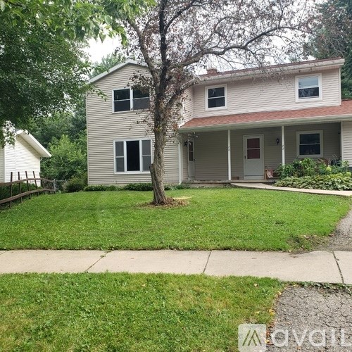 A house with a tree in front of it.