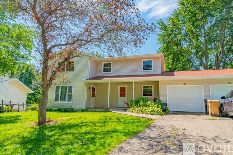 A house with a tree in front of it.