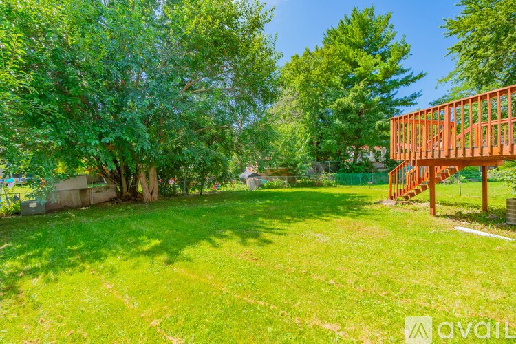 A backyard with a wooden structure and trees.
