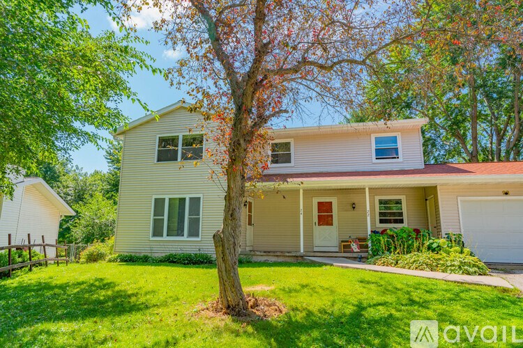 A house with a tree in front of it.