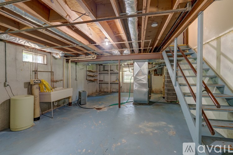 A room with a staircase and a window.