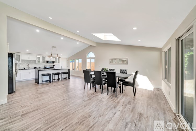 A spacious dining area with a table set for six.