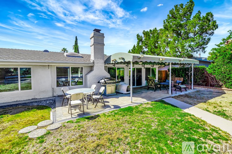A house with a patio and a table set for four.