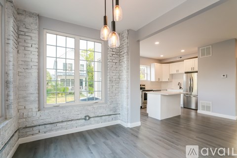A modern kitchen with white cabinets and a large island.