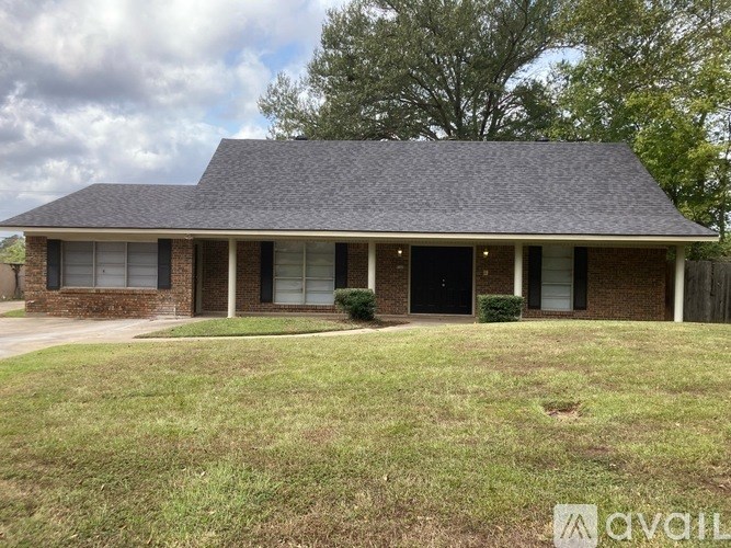 A house with a grey roof and a black door.