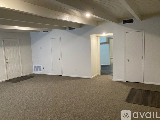 A room with white walls and a carpeted floor.