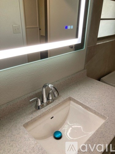 A bathroom sink with a blue faucet.