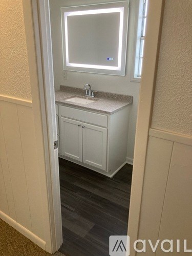 A bathroom with a sink and a mirror.