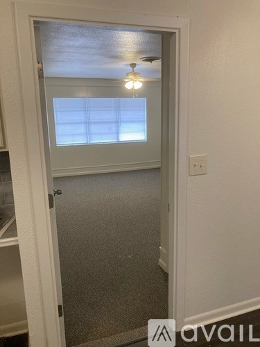 A white door with a glass window and a light on the ceiling.