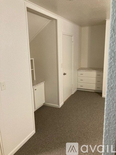 A small bedroom with a bed, dresser, and mirror.