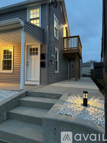 A house with a white door and a small porch.